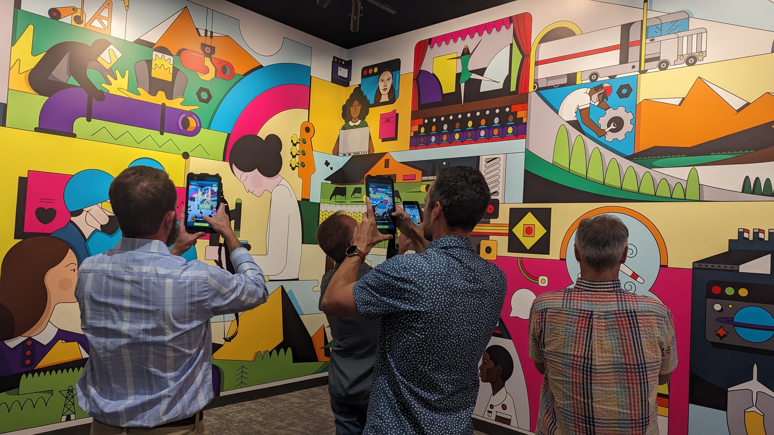 people taking photos of a mural